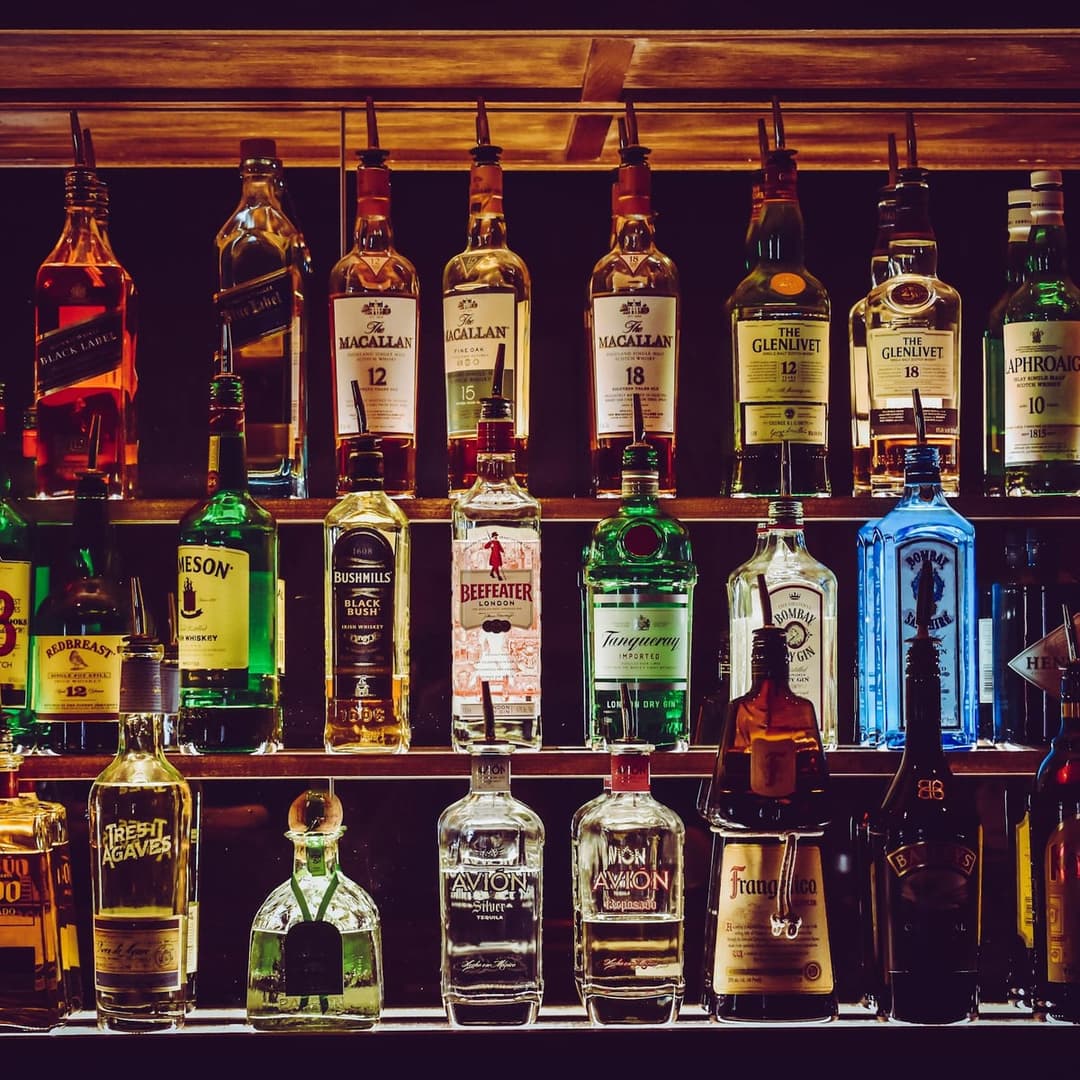 Backlit bar bottles at night