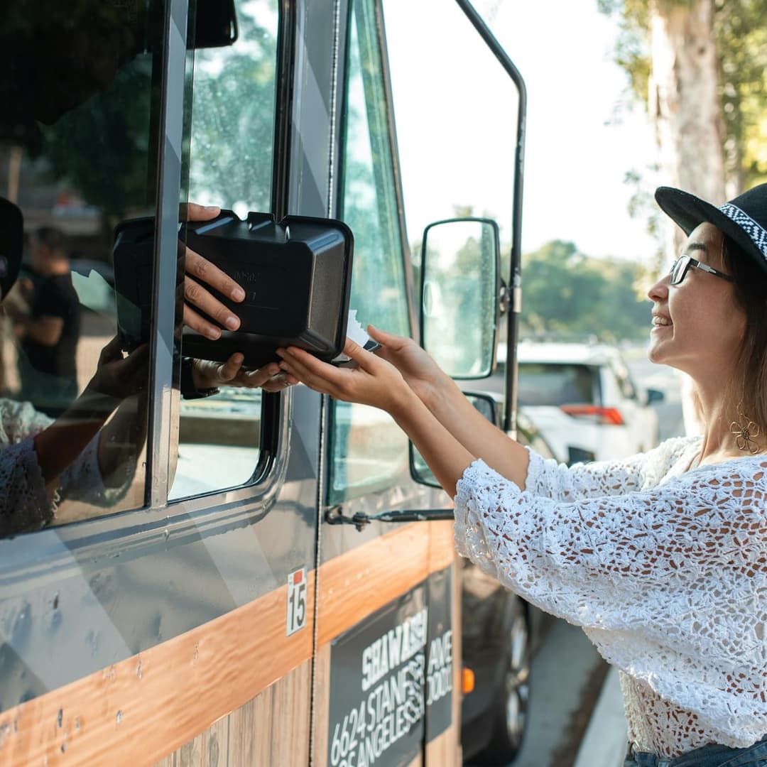 Customer ordering from a busy food truck window